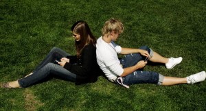 Finnish youngsters communicate by exchanging SMS messages in Kaivopuisto park